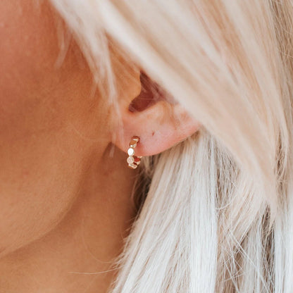 Gold cora huggies on models ear