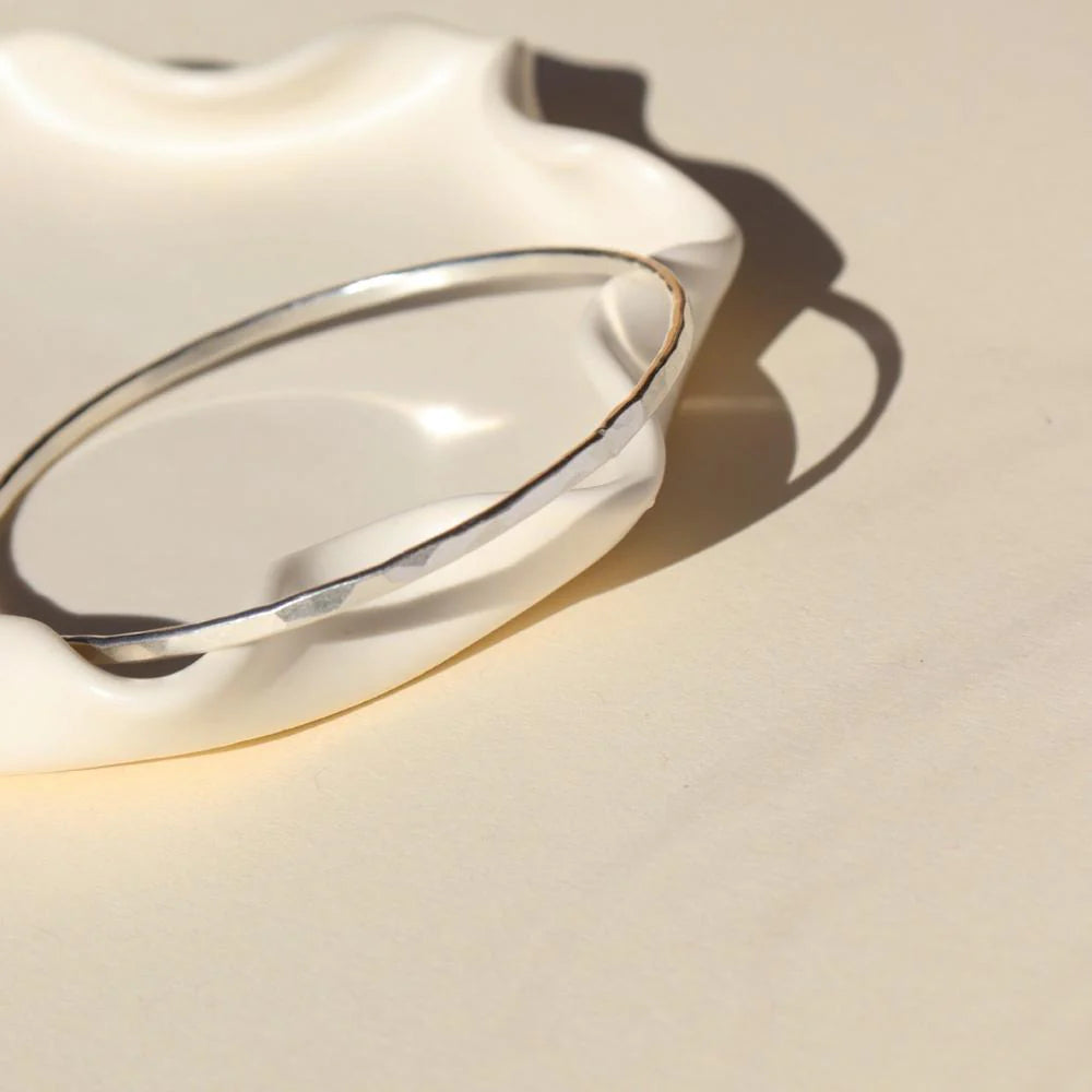 Hammered bangle in silver front and side view