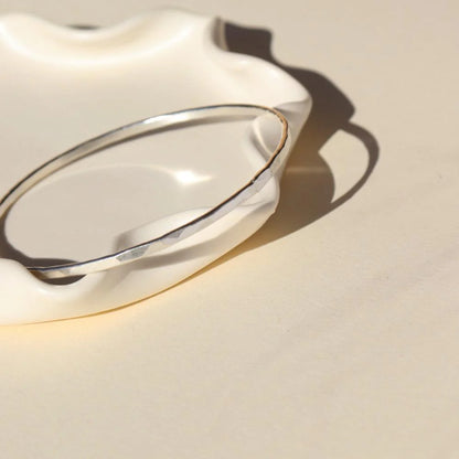 Hammered bangle in silver front and side view