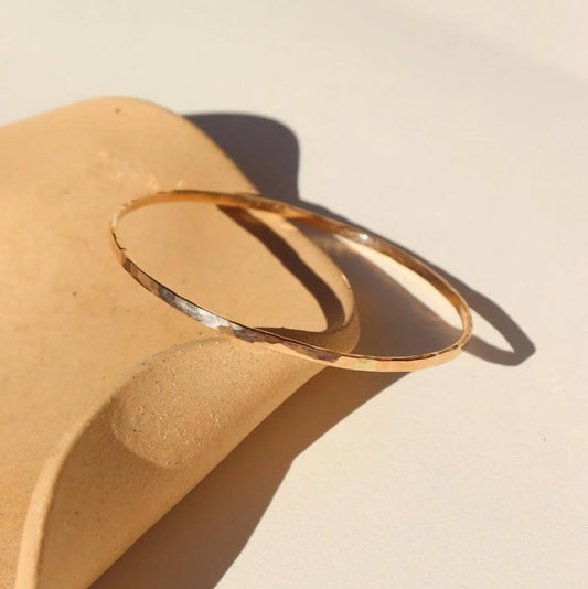 Hammered bangle in gold front and side view
